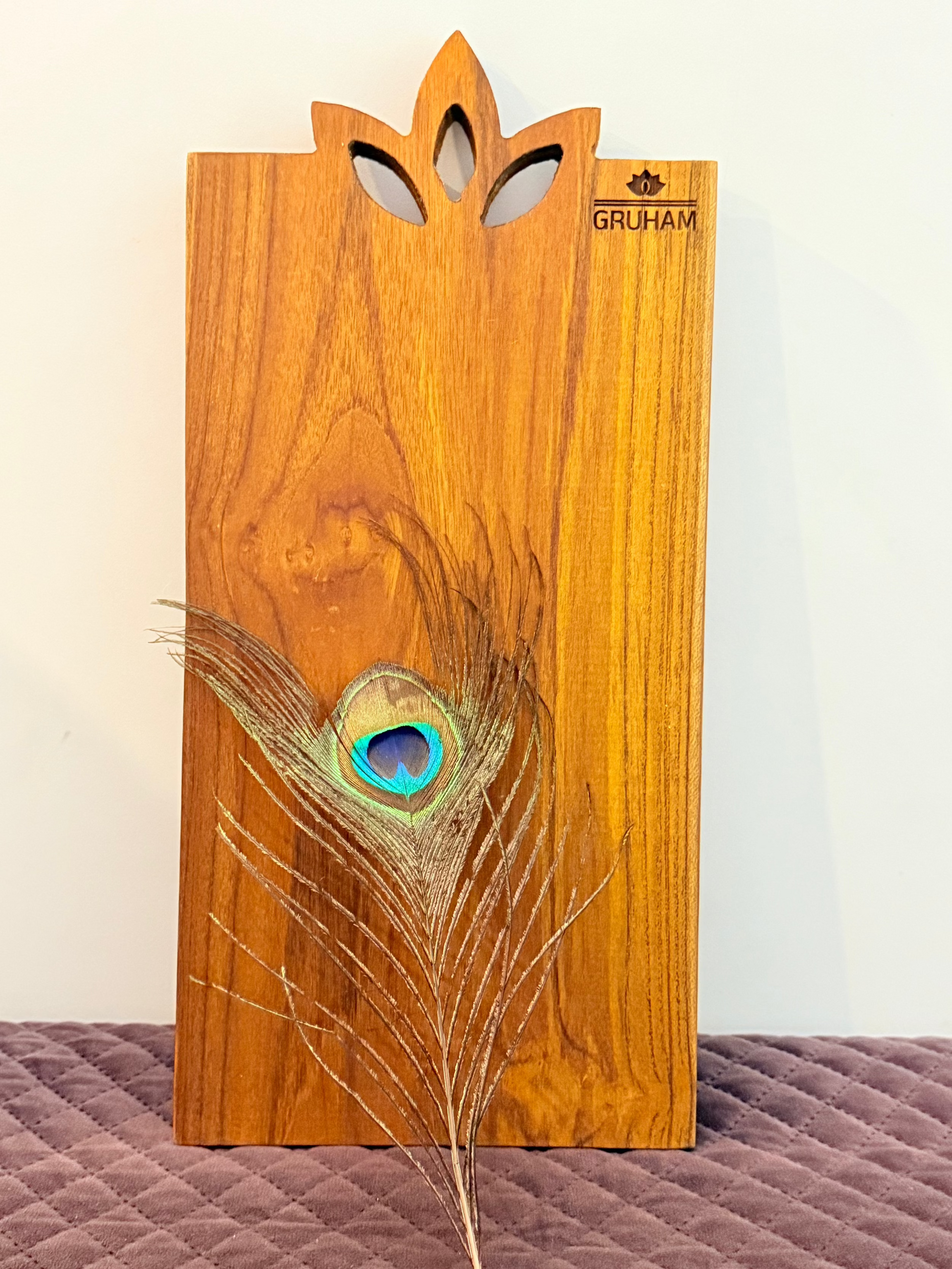 Handcrafted teakwood board with symbolic lotus design, made for cutting and serving