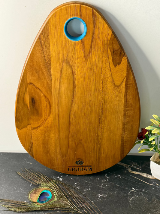 Oval teakwood cutting and serving board by GRUHAM with bum-inspired curves